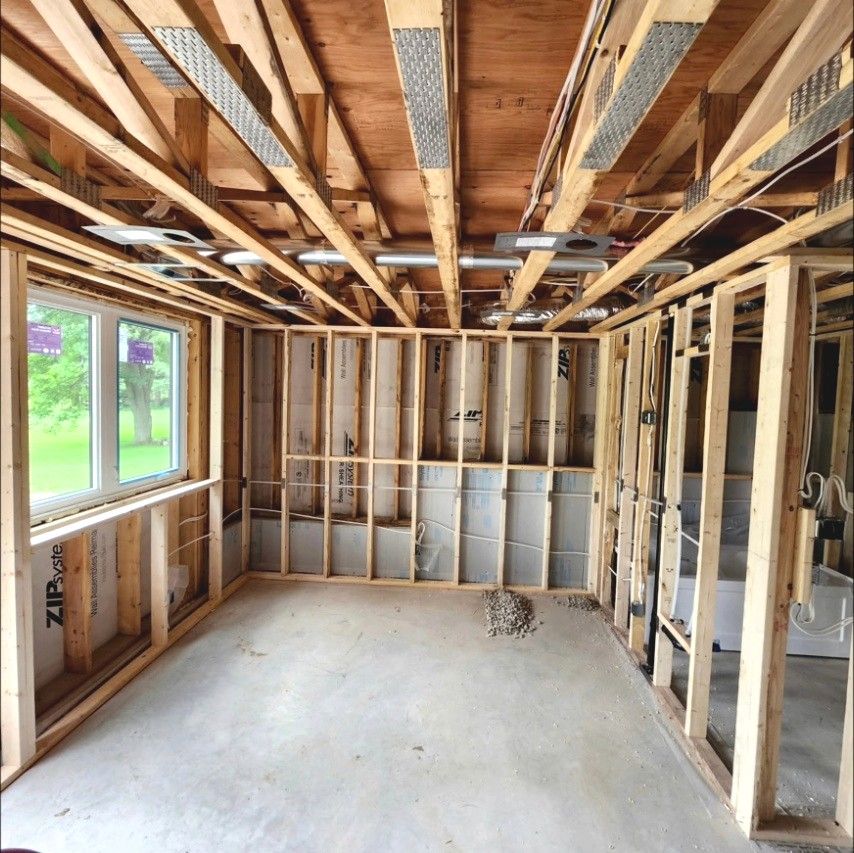 Framed basement room with ducting, pot light housings and wiring in place