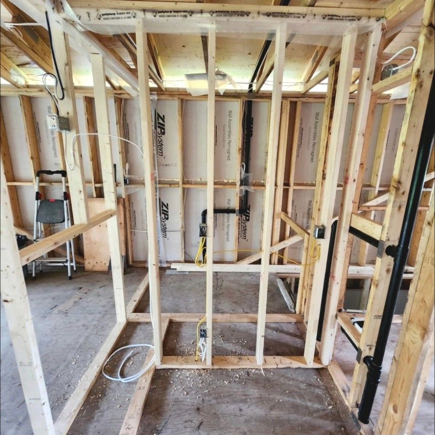 Framed bathroom with boxes and wiring roughed in before drywall