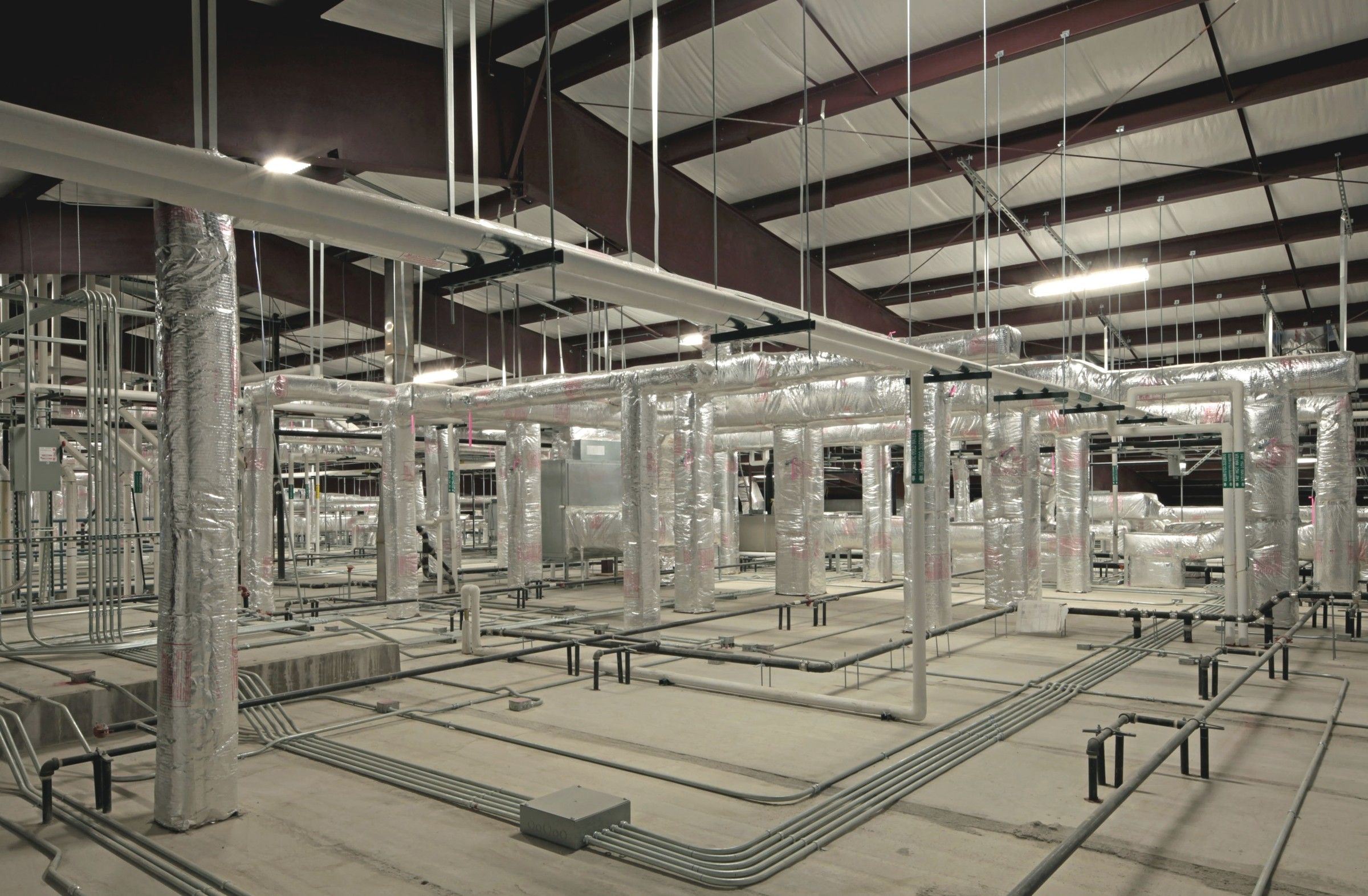 Conduit runs across a large commercial building under construction