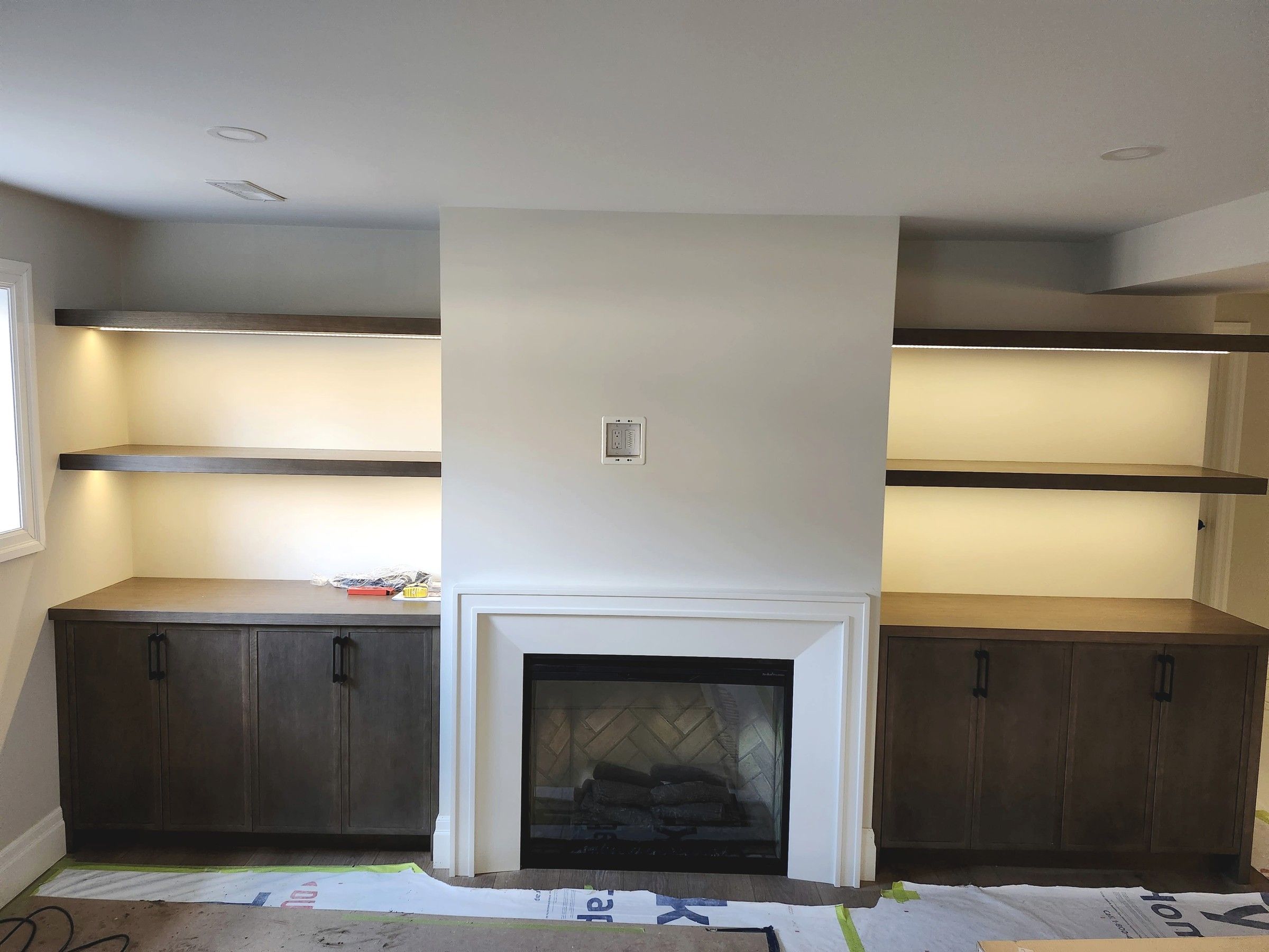 Low voltage shelf lighting beside a fireplace