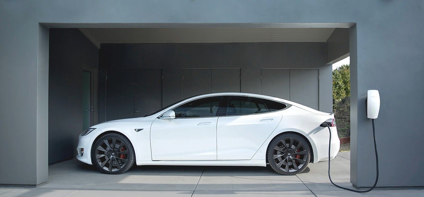 Electric car charging from a wall-mounted charger in a garage