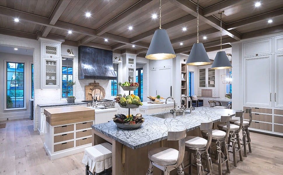 Kitchen with pendant lights over an island and pot lights in the ceiling